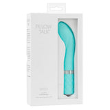 Turkis Sassy G-punkt vibrator med bøyd tupp, riller og Swarovski krystaller i hvit emballasje.