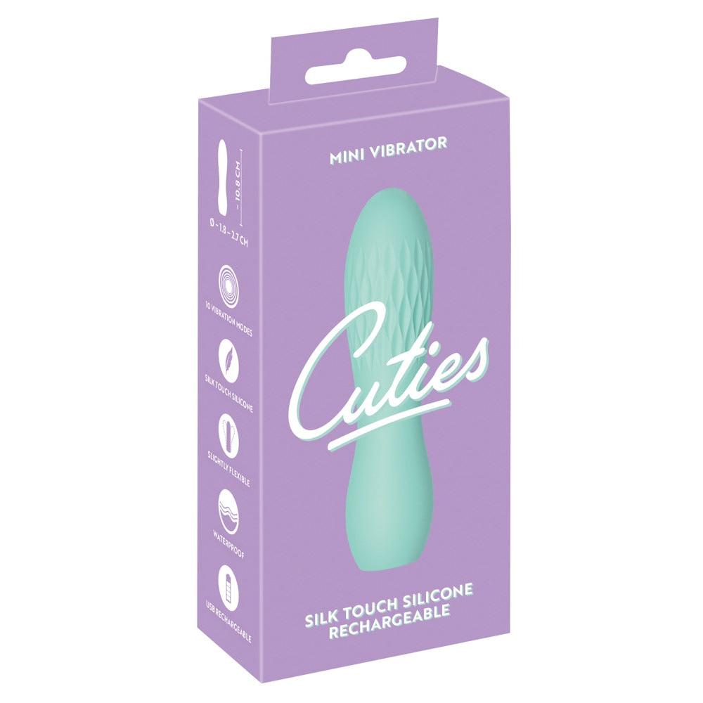 Turkis Cuties minivibrator i silkemyk silikon med rillet overflate, vist i lilla emballasje.