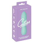 Turkis Cuties minivibrator i silkemyk silikon med rillet overflate, vist i lilla emballasje.