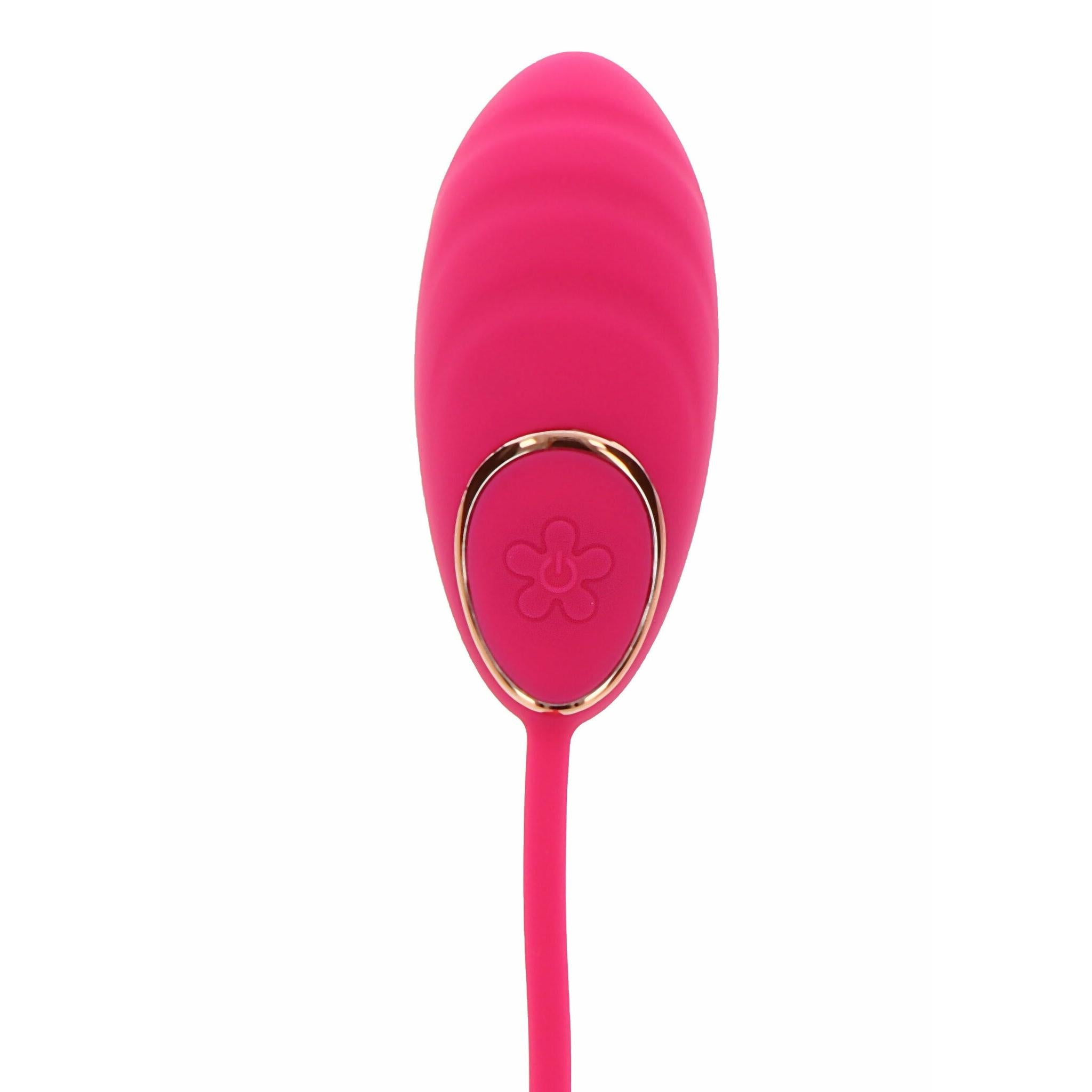Fuchsia silikon vibrasjonsegg med gullkantet kontrollknapp og blomsterdesign.