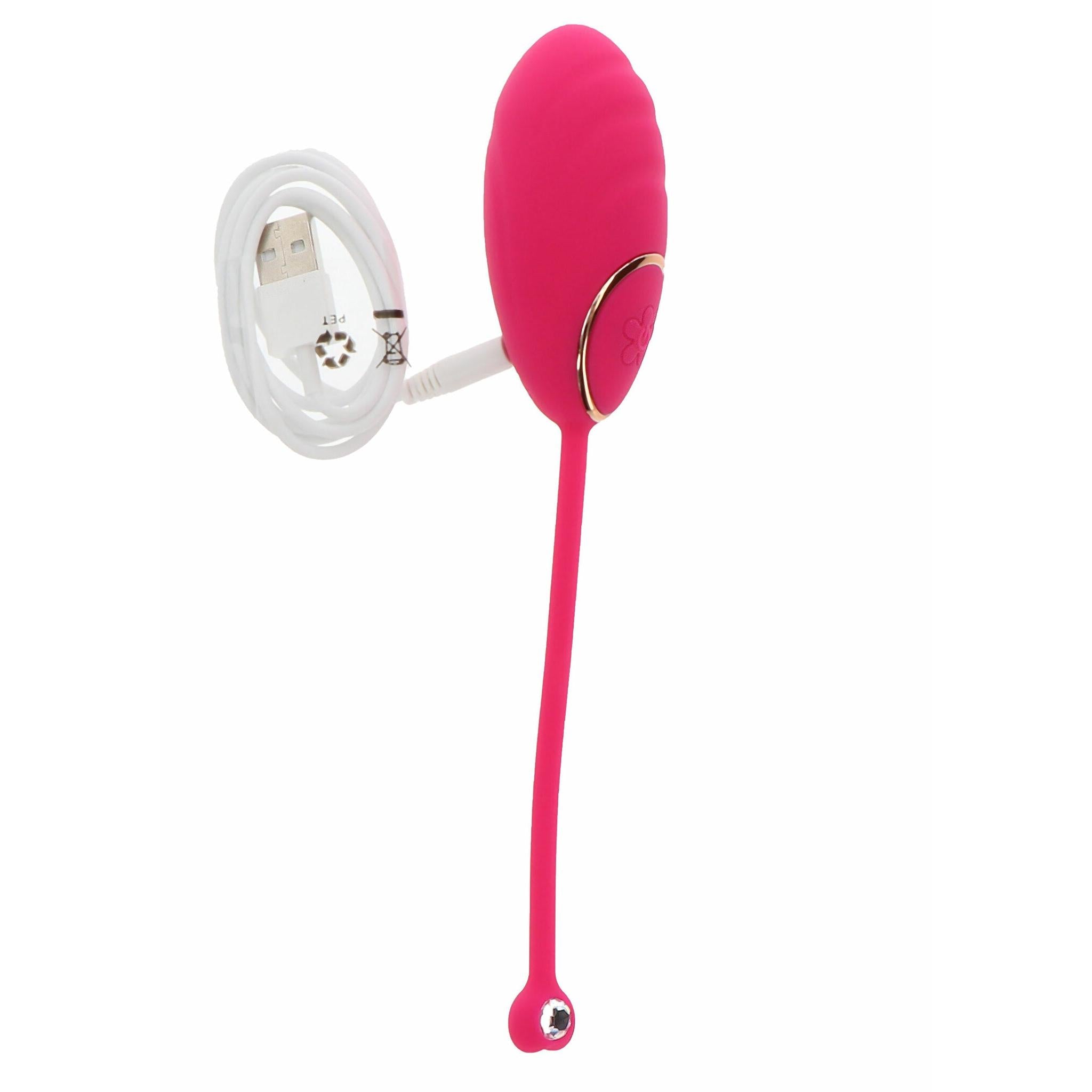 Rosa silikon vibrasjonsegg med gullfarget kontrollknapp og hvit USB-ladekabel.
