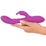Javida Thumping Rabbit Vibrator i lilla silikon, holdt i en hånd, med buet tupp og klitorisstimulator.