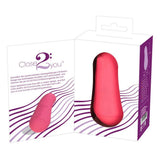 Corallino klitorisvibrator i matt rosa silikon, vist i og utenfor hvit emballasje.