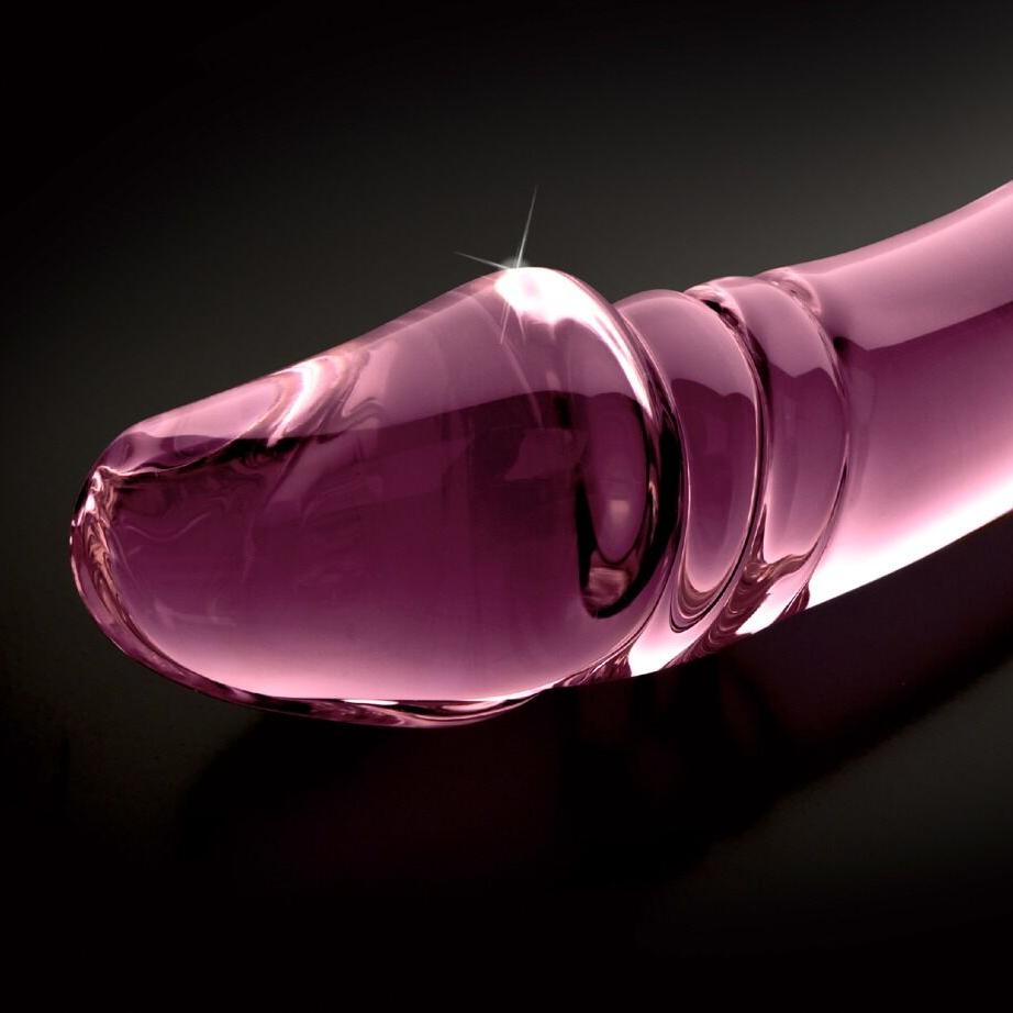 Glatt, rosa glassdildo med markert penishode og rillet, bølgende mønster.