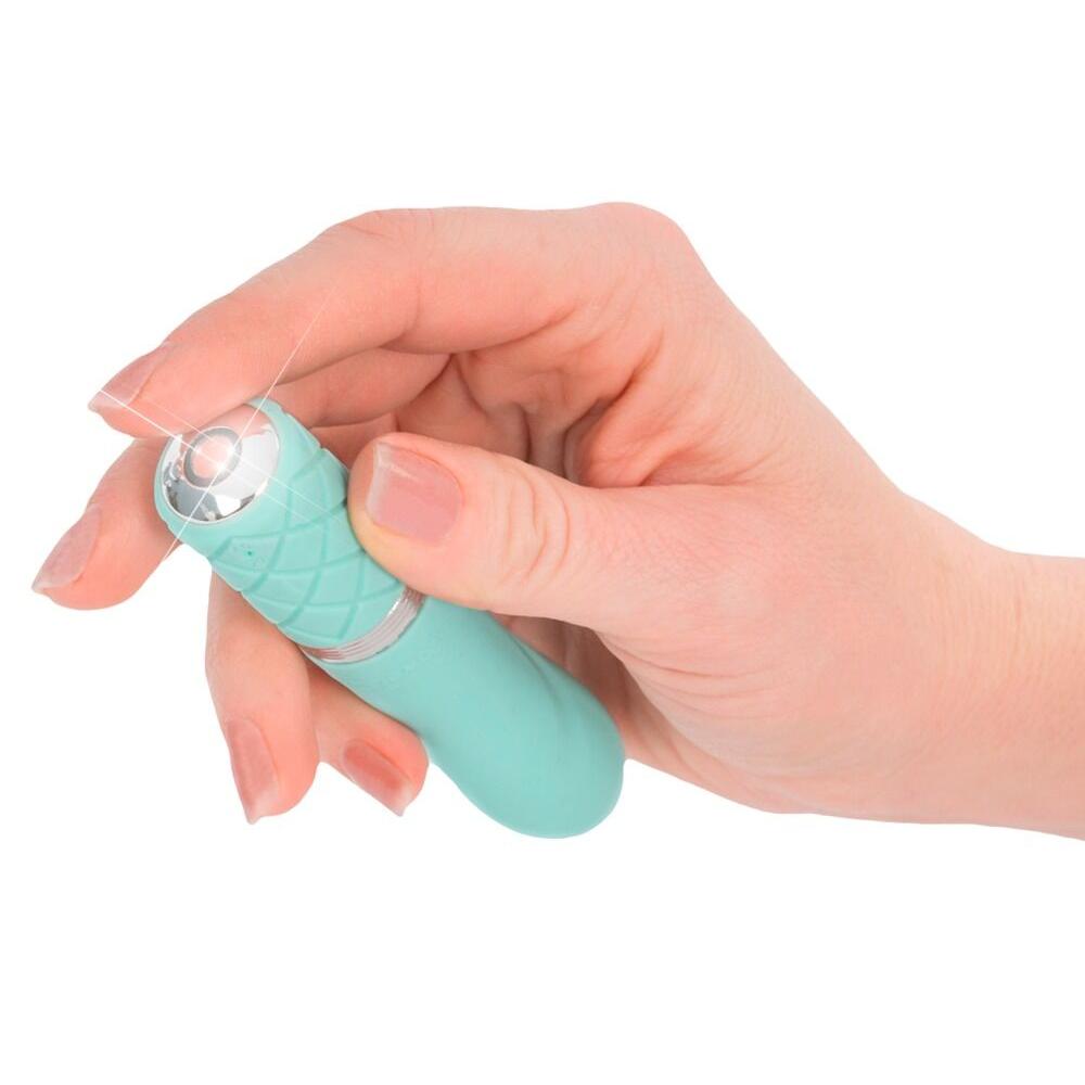 Hånd holder en mintgrønn silikonvibrator med diamantmønster og Swarovski-krystallknapp.