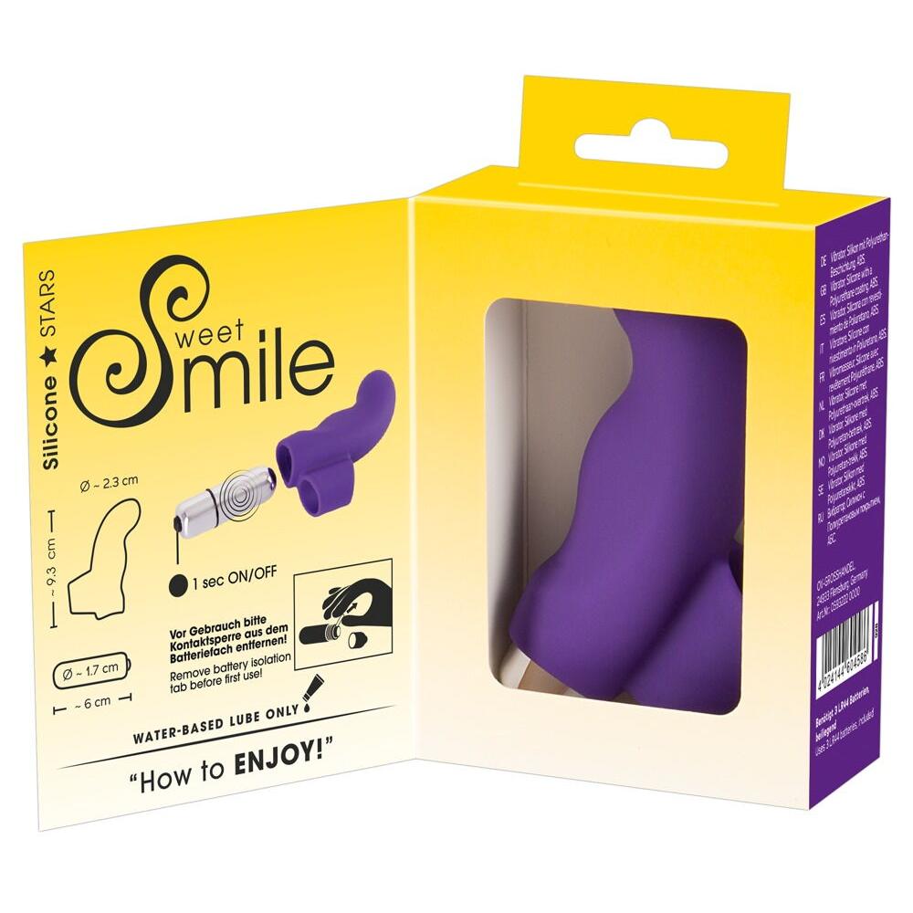 Lilla Sweet Smile fingervibrator i silikon med fingergrep, vist i åpen emballasje med instruksjoner.