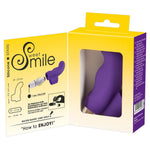 Lilla Sweet Smile fingervibrator i silikon med fingergrep, vist i åpen emballasje med instruksjoner.