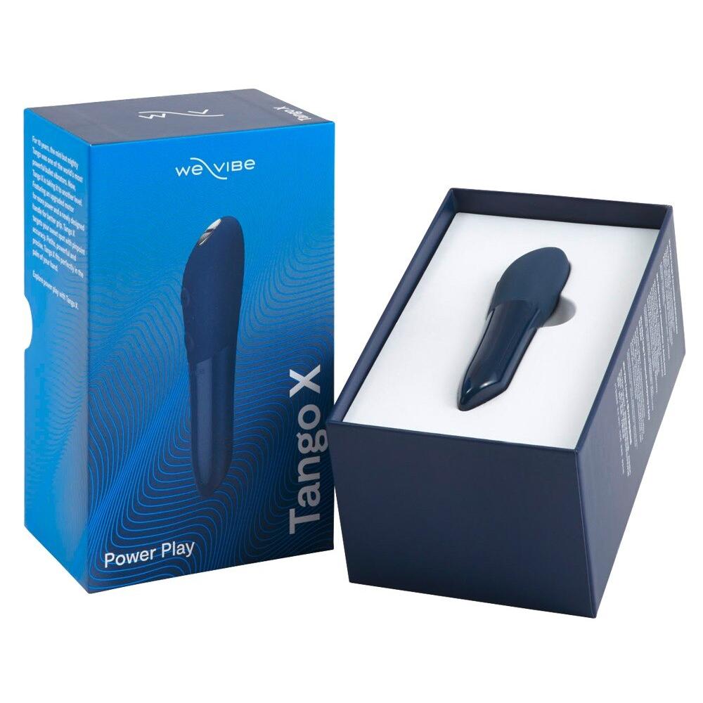 Blå We-Vibe Tango X klitorisvibrator i en åpen eske, ved siden av den lukkede produktemballasjen.