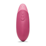 Mørk rosa Womanizer VIBE klitorisstimulator i silikon med ergonomisk design og kontrollknapper.