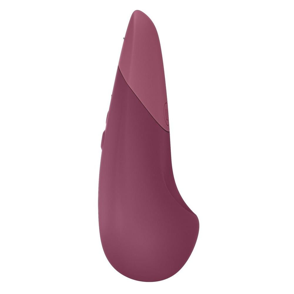 Womanizer VIBE klitorisstimulator i mørk rosa silikon med ergonomisk design og kontrollknapper.