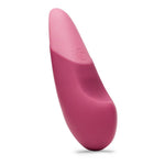 Womanizer VIBE klitorisstimulator i mørk rosa silikon med lys rosa tupp og kontrollknapp.
