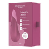 Womanizer VIBE klitorisstimulator i mørk rosa eske med produktfunksjoner og UltraWave Vibration-logo.