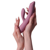 Trysta Neo rabbitvibrator i silkemyk lilla silikon, holdt i to hender.