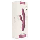 Trysta Neo interaktiv rabbitvibrator i lilla silikon med G-punkt massasjekule, vist i hvit emballasje.