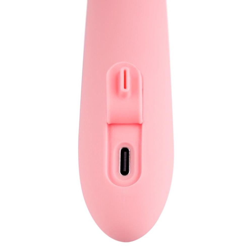 Nærbilde av den rosa Mora Neo rabbitvibratoren, som viser ladeporten og en kontrollknapp.