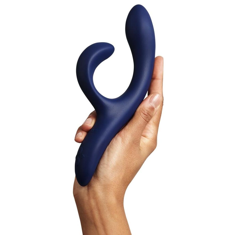 Hånd holder en dyp blå We-Vibe Nova 2 rabbitvibrator med fleksibel klitorisstimulator og ergonomisk design.