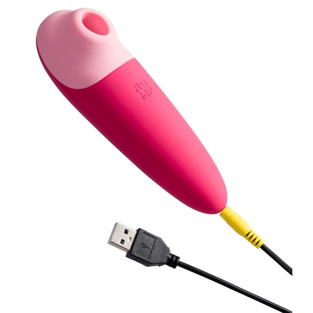 ROMP Shine X lufttrykksvibrator i rosa silikon med USB-ladekabel.