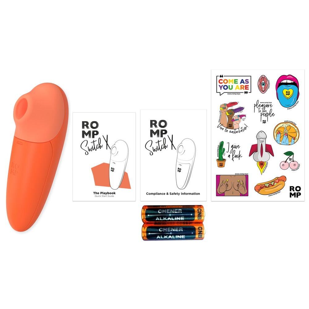 Oransje ROMP Switch X sugevibrator, to manualer, klistremerker og to AA-batterier.