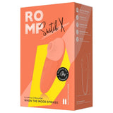 ROMP Switch X sugevibrator i ferskenfarget silikon, vist i emballasje med produktfunksjoner.