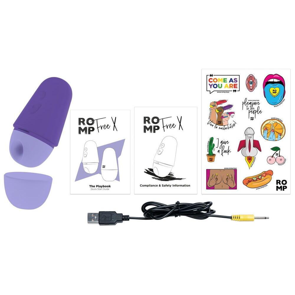 Lilla ROMP Free X sugevibrator med ladeledning, manualer og klistremerker.