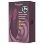 Womanizer NEXT lilla sugevibrator med Soft Touch-overflate og 3D Pleasure Air-teknologi i esken.