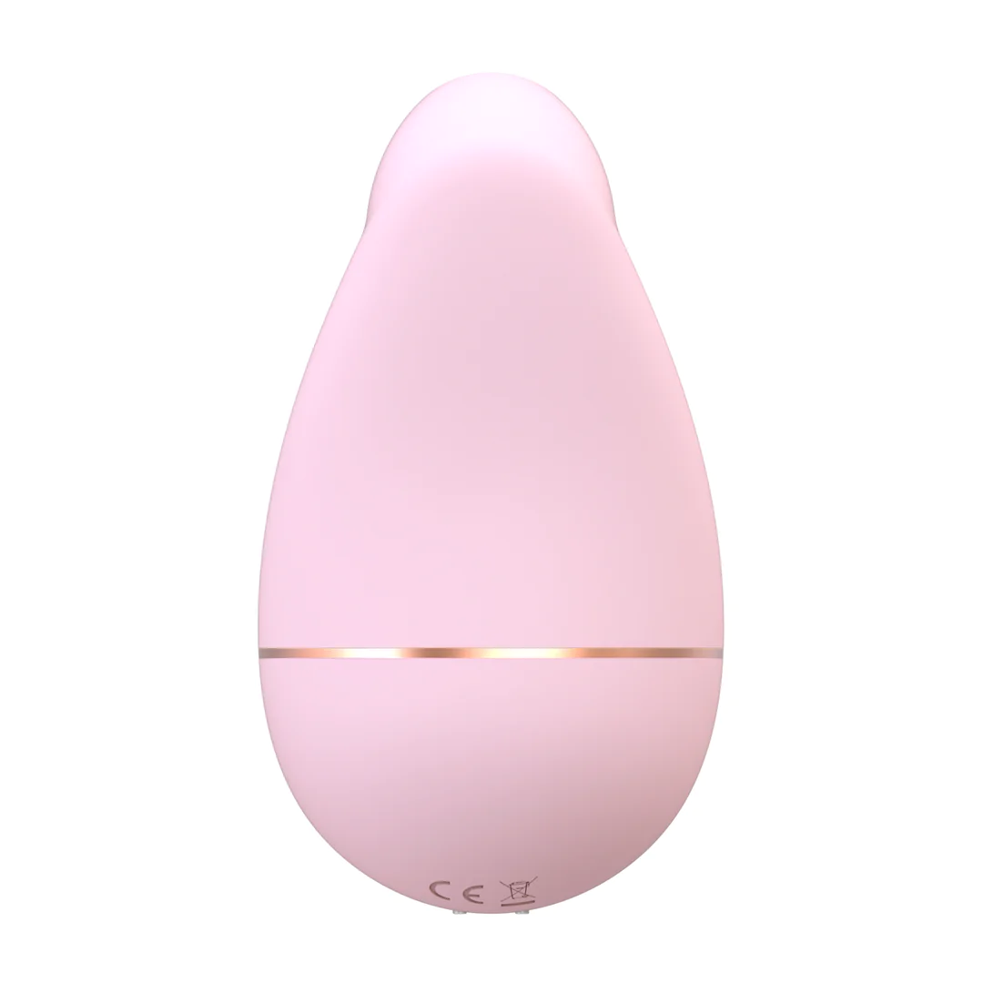 Lys rosa, dråpeformet sugevibrator i medisinsk silikon med en tynn gullring.