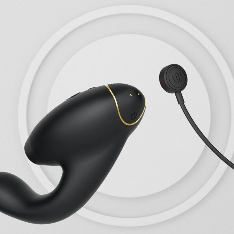 Womanizer DUO 2 Sort klitoris- og G-punkt stimulator med gullkant og magnetisk lader.