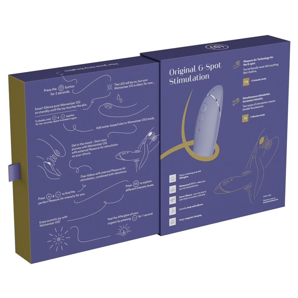 Womanizer OG lilla G-punktvibrator med Pleasure Air-teknologi, vist i åpen emballasje med instruksjoner.