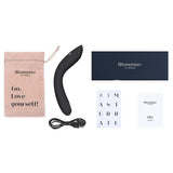 Womanizer OG sort G-punktvibrator med Pleasure Air-teknologi, ladekabel, manual og oppbevaringspose.