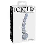 Hvit eske med "ICICLES hand blown glass massager" og et bilde av en bølget glassdildo med perlede kuler.