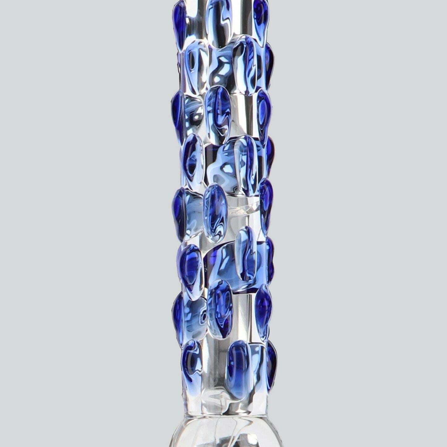 ToyJoy Glass Worxx Diamond Dazzler, en glassdildo med blå stimuleringsknopper og elegant buet silhuett.