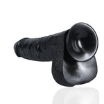 Ekstra stor, rett, svart dildo i PVC med realistisk tekstur, årer, glans og pung, samt sugekopp.