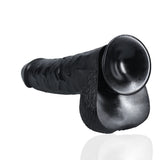 Ekstra stor, rett, svart dildo i PVC med realistisk tekstur, årer, glans og pung, samt sugekopp.