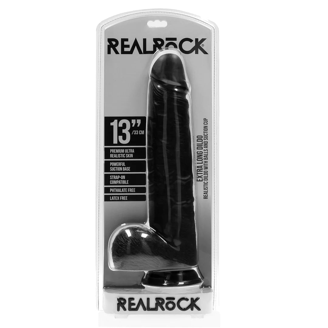 Sort, realistisk 33 cm dildo med baller og sugekopp i RealRock-emballasje.