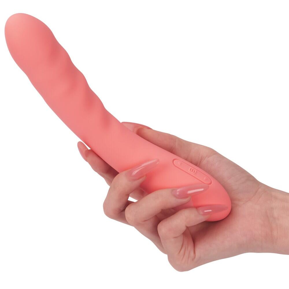 Ava Neo støtvibrator i rosa silikon, holdt i en hånd, med kontrollknapper på siden.