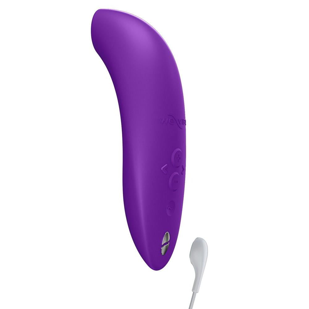 We-Vibe Melt 2 lilla lufttrykksvibrator i silikon med kontrollknapper og magnetisk ladekabel.
