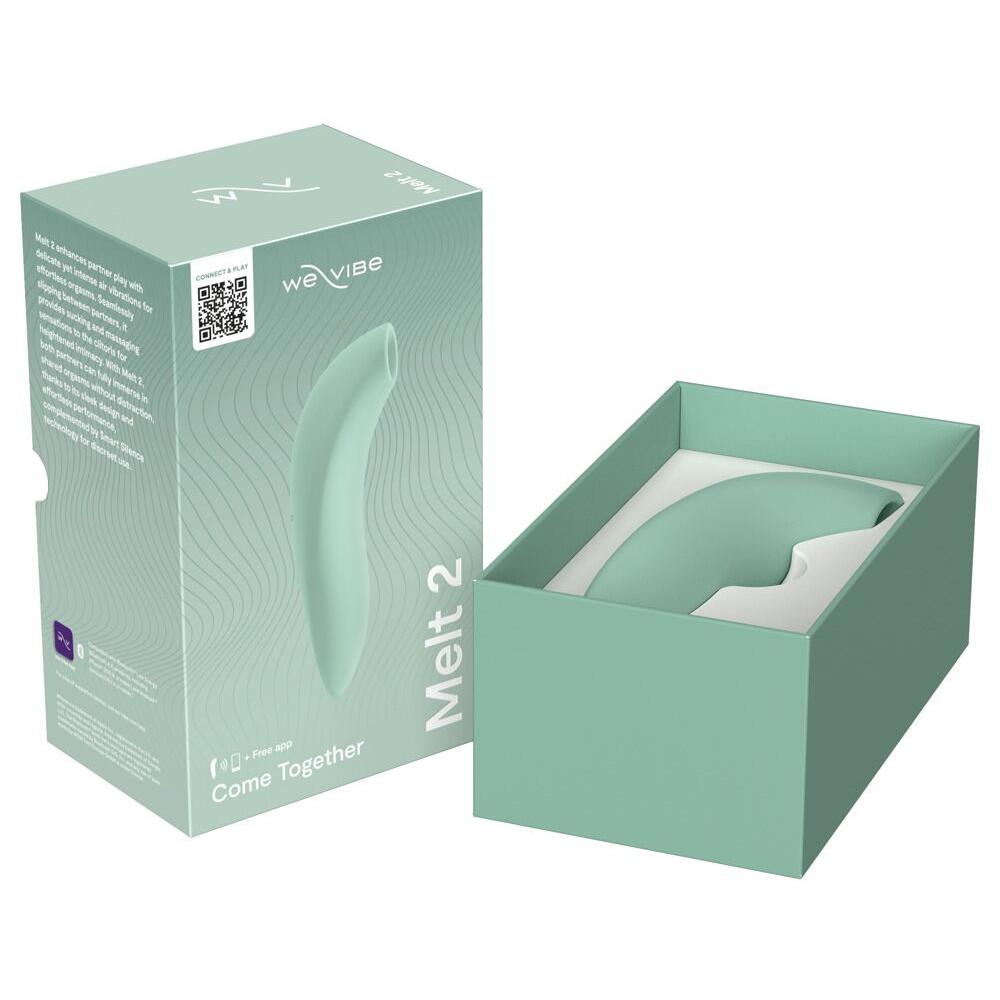 We-Vibe Melt 2 lufttrykksvibrator i dus grønn silikon, vist i åpen og lukket produktemballasje.