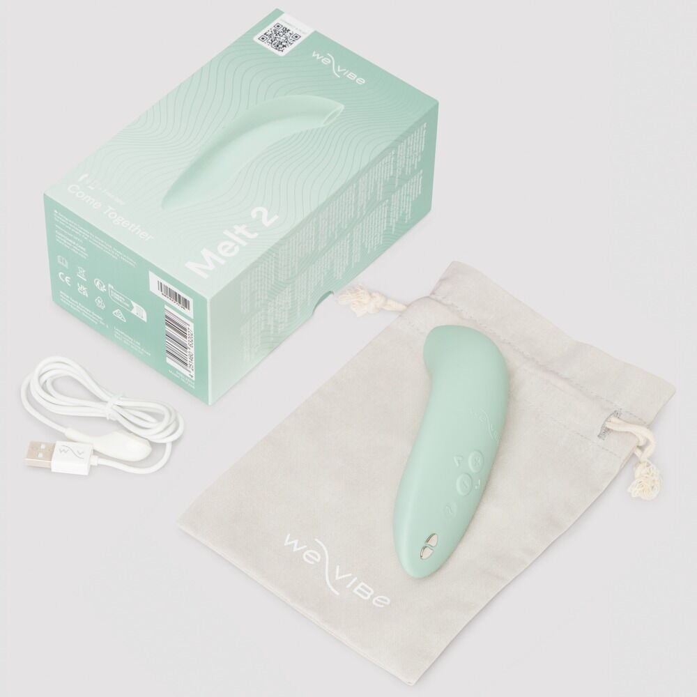 We-Vibe Melt 2 lufttrykksvibrator i dus grønn, med eske, ladekabel og oppbevaringspose.