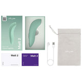 We-Vibe Melt 2 lufttrykksvibrator i dus grønn, med ladeledning, oppbevaringspose og emballasje.